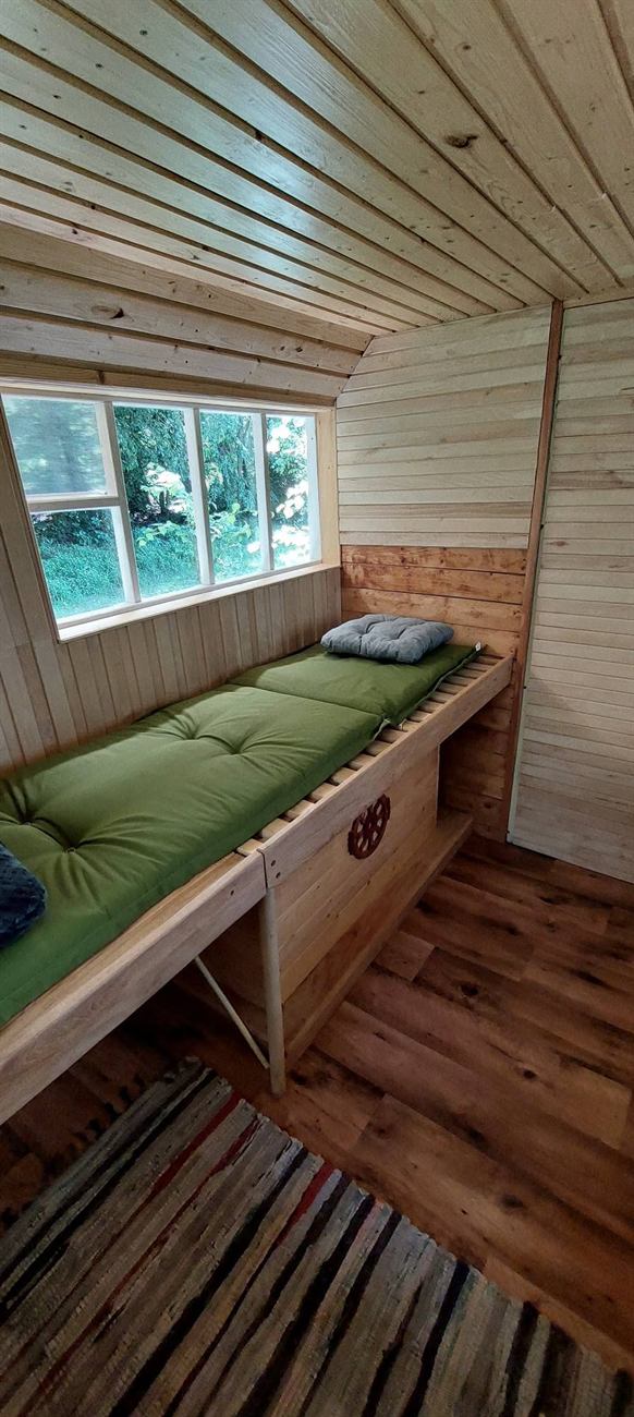 Inside the bee hut with view onto forest