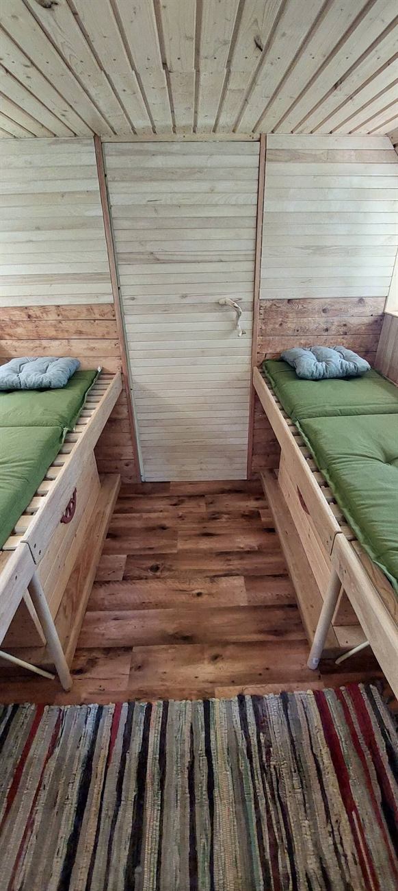 Bee therapy hut with beds above beehives