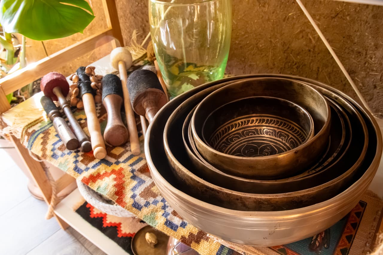 Singing bowls and mallets on a shelf